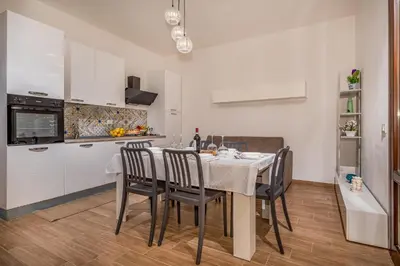 a kitchen and dining room with a table and chairs at Casa Del Golfo SantAntonino in Castellammare del Golfo