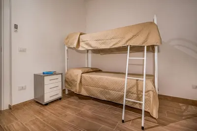 a bedroom with a bunk bed and a wooden floor at Casa Del Golfo SantAntonino in Castellammare del Golfo