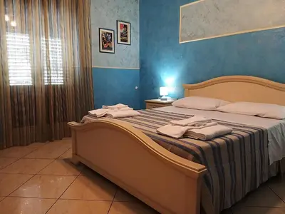 a bedroom with a large bed with towels on it at la Maison 