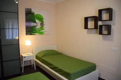 a bedroom with a green bed in a room at Palermo Holidays in Mondello