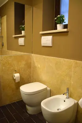 a bathroom with a toilet and a sink at Palermo Holidays in Mondello