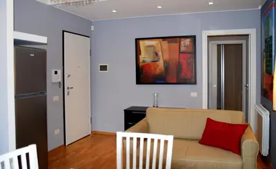 a living room with a couch and a red pillow at Palermo Holidays in Mondello