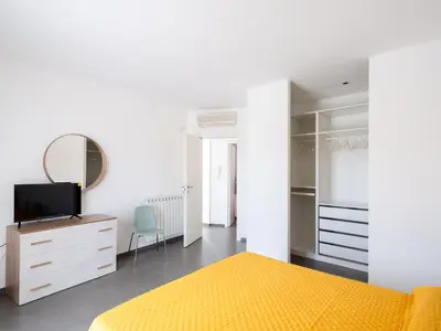 a bedroom with a yellow bed and a mirror at Villa Timpi Rossi Total Relax in Alcamo