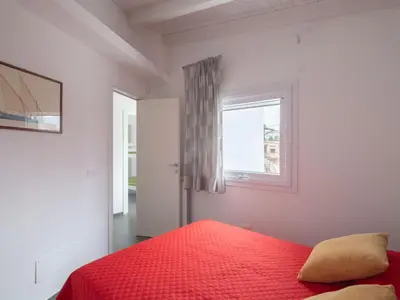a bedroom with a red bed and a window at Villa Timpi Rossi Total Relax in Alcamo