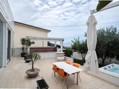 a patio with a table and an umbrella at Villa Timpi Rossi Total Relax in Alcamo