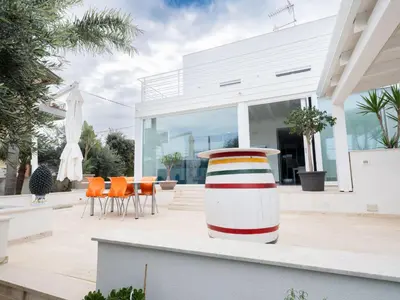 a house with a large vase sitting on a patio at Villa Timpi Rossi Total Relax in Alcamo