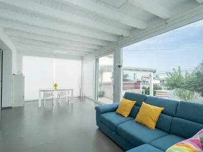 a living room with a blue couch and a table at Villa Timpi Rossi Total Relax in Alcamo