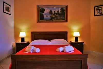 a bedroom with a large bed with two white pillows at B&B Oleaster - Bolognetta in Bolognetta