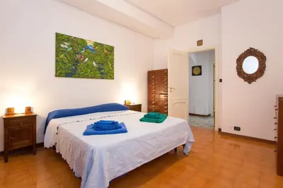 a bedroom with a bed with blue towels on it at Casa Ibiscus in Mondello