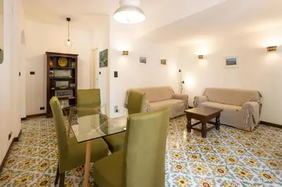 a living room with a glass table and chairs at Casa Ibiscus in Mondello