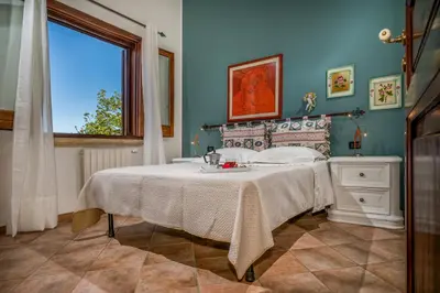 a bedroom with a bed with a sink and a window at Villa Miceli con piscina privata in Scopello
