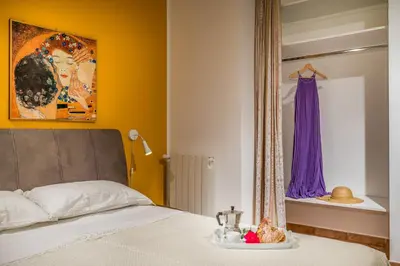a bedroom with a bed and a window with a dress on a shelf at Villa Miceli con piscina privata in Scopello