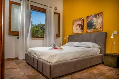 a bedroom with a bed with a table on it at Villa Miceli con piscina privata in Scopello
