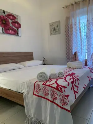 a bedroom with a bed with towels on it at Appartamento Casa Trento in Castellammare del Golfo