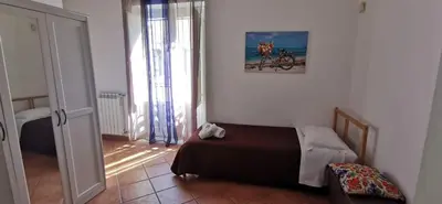 a bedroom with a bed in the corner of a room at Casa Bellini in Palermo