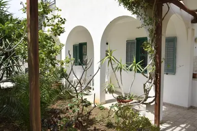 a green door in a room with a window at Da Silvia, a due passi dal mare in San Vito lo Capo