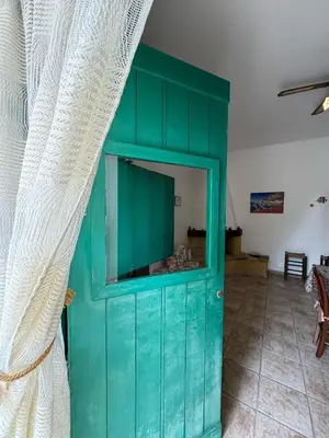 a kitchen with a table and chairs and a kitchen with a table and a table at Da Silvia, a due passi dal mare in San Vito lo Capo