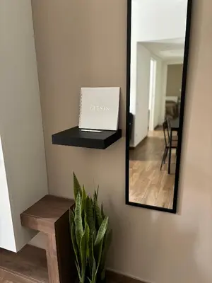a mirror with a laptop on a shelf and a plant at Come fossi a casa in Palermo