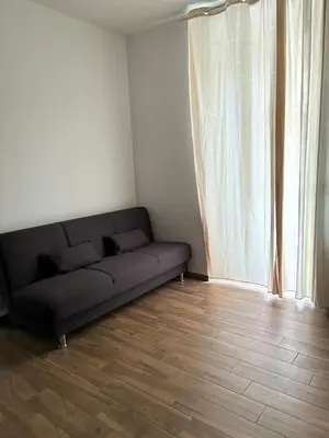 a black couch in a room with a window at Come fossi a casa in Palermo