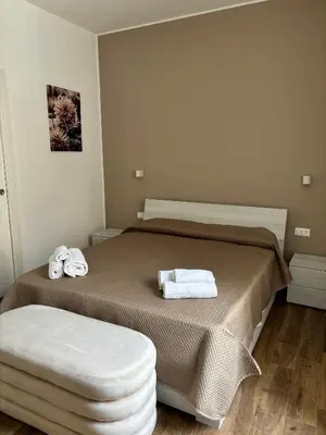 a bedroom with a bed with two towels on it at Come fossi a casa in Palermo