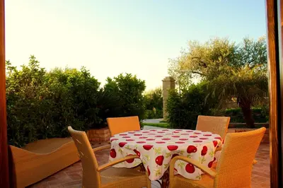 a table and chairs with a polka dotted table and chairssenalsenal at Villa Cattleya in Campofelice di Roccella