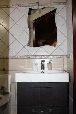 a bathroom with a sink and a mirror at Villa Cattleya in Campofelice di Roccella