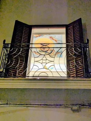 a window with a painting on it on a building at Casa Rosa Castellammare del Golfo in Castellammare del Golfo