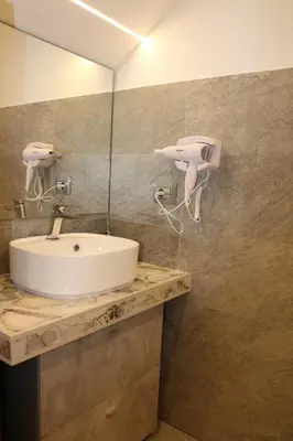 a bathroom with a sink and a mirror at ALLUMARO HOUSE in Castellammare del Golfo