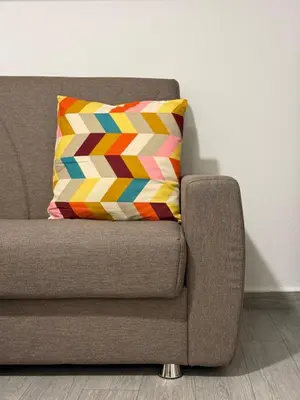 a colorful pillow sitting on a couch in a room at A CASA DI IDA in Palermo