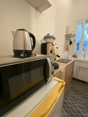 a kitchen with a microwave on top of a counter at A CASA DI IDA in Palermo