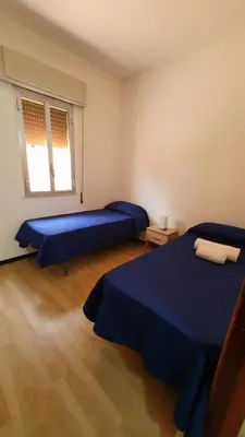 a bedroom with two beds and a window at Villa Chifeci Scopello - Appartamento Rosso in Scopello