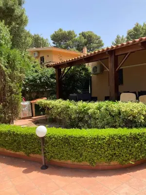 a garden with green bushes and a pavilion at Villa Chifeci Scopello - Appartamento Verde in Scopello