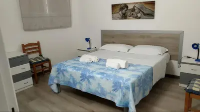 a bedroom with a bed with two towels on it at Villa Chifeci Scopello - Appartamento Verde in Scopello