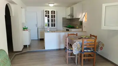a kitchen with a table and chairs in a room at Villa Chifeci Scopello - Appartamento Verde in Scopello