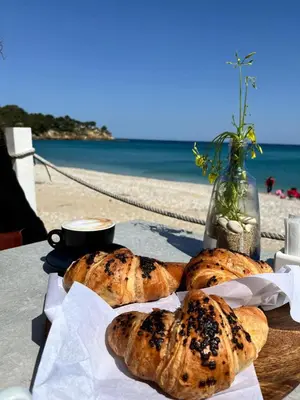 a table with three loaves of bread on a table near the beach at Villa Chifeci Scopello - Appartamento Verde in Scopello