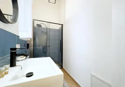 a bathroom with a white sink and a shower at Solemar Sicilia - Casa Markiz in Palermo