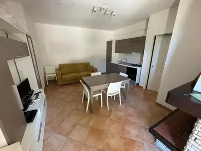 a small living room with a table and a couch at Villa Chifeci Scopello - Appartamento La Zàgara in Scopello