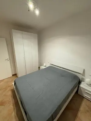 a bedroom with a large bed and white cabinets at Villa Chifeci Scopello - Appartamento La Zàgara in Scopello