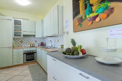a kitchen with a bowl of fruit on a counter at Villa Le Terrazze in Cefalù