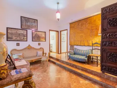 a staircase in a building with a wooden door at Palazzo del Bono suites in Palermo