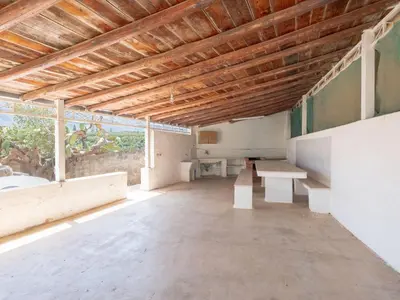 a large room with a table and benches in it at [Baia di Guidaloca] Villino Scopello Free Parking in Scopello