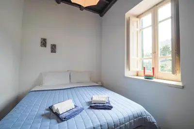 a bedroom with a bed with two towels on it at Casetta Bianca Sant'Elia in Porticello