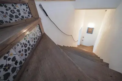 a hallway with a stairway with a stair case and a stair case at Casetta Bianca Sant'Elia in Porticello
