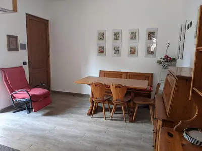 a dining room with a wooden table and chairs at Rosalba apartments - cheap and characteristic in Palermo