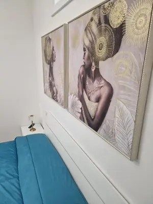 a wall with two pictures of a woman on it at Casa Gaia in Terrasini