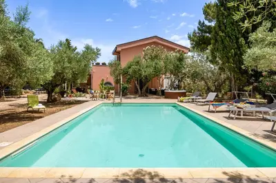 a swimming pool with chairs and a house at Villa Giovanna con Piscina by Wonderful Italy in Castellammare del Golfo