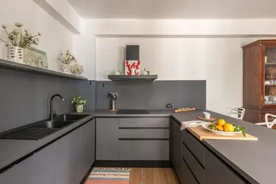 a kitchen with a sink and a bowl of fruit on a counter at Villa Giovanna con Piscina by Wonderful Italy in Castellammare del Golfo