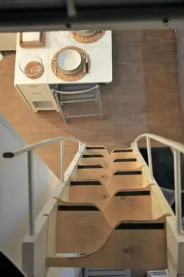 a view of a room with a staircase and a table at Porta delle Stelle Vucciria in Palermo