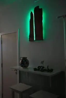 a room with a green light on a wall at Porta delle Stelle Vucciria in Palermo