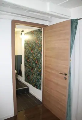 a bathroom with a painting on the wall next to a door at Porta delle Stelle Vucciria in Palermo